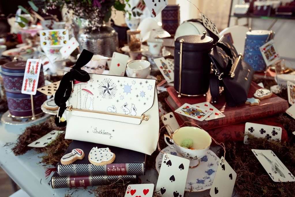 A table topped with lots of cards and a purse