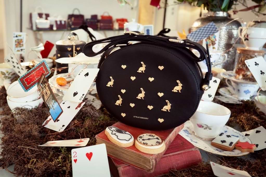 A purse sitting on top of a pile of cards