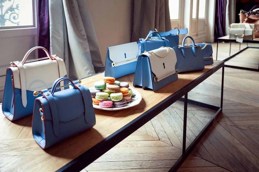 A table topped with blue bags and a plate of food