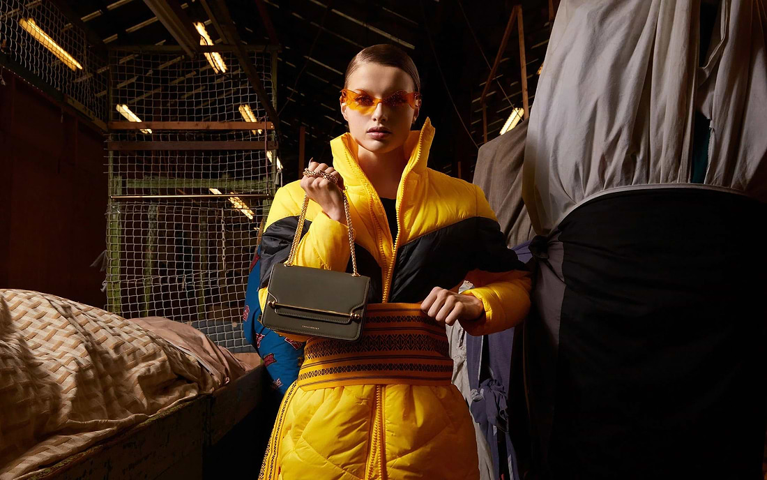 A man in a yellow jacket and sunglasses