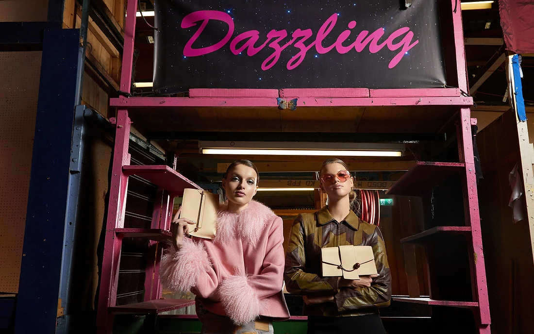 A man and a woman standing in front of a sign