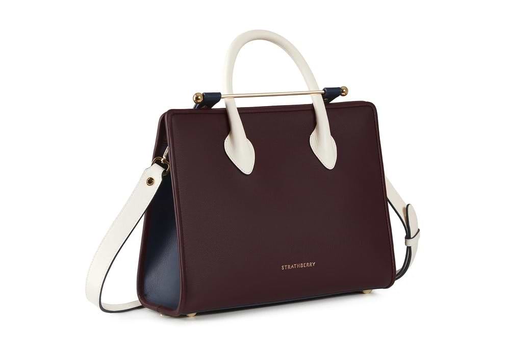 A brown and white handbag on a white background