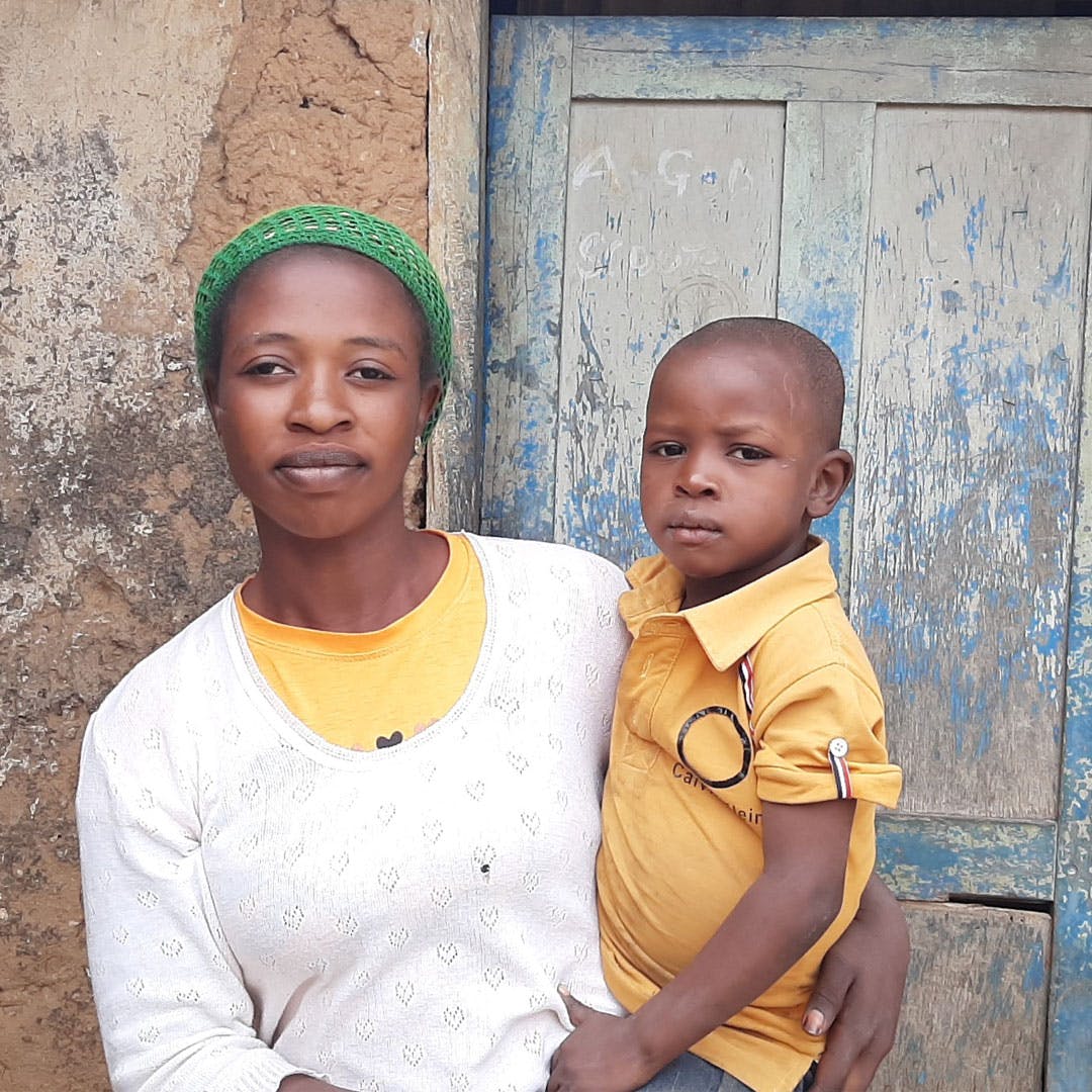 A woman and child standing in front of a door