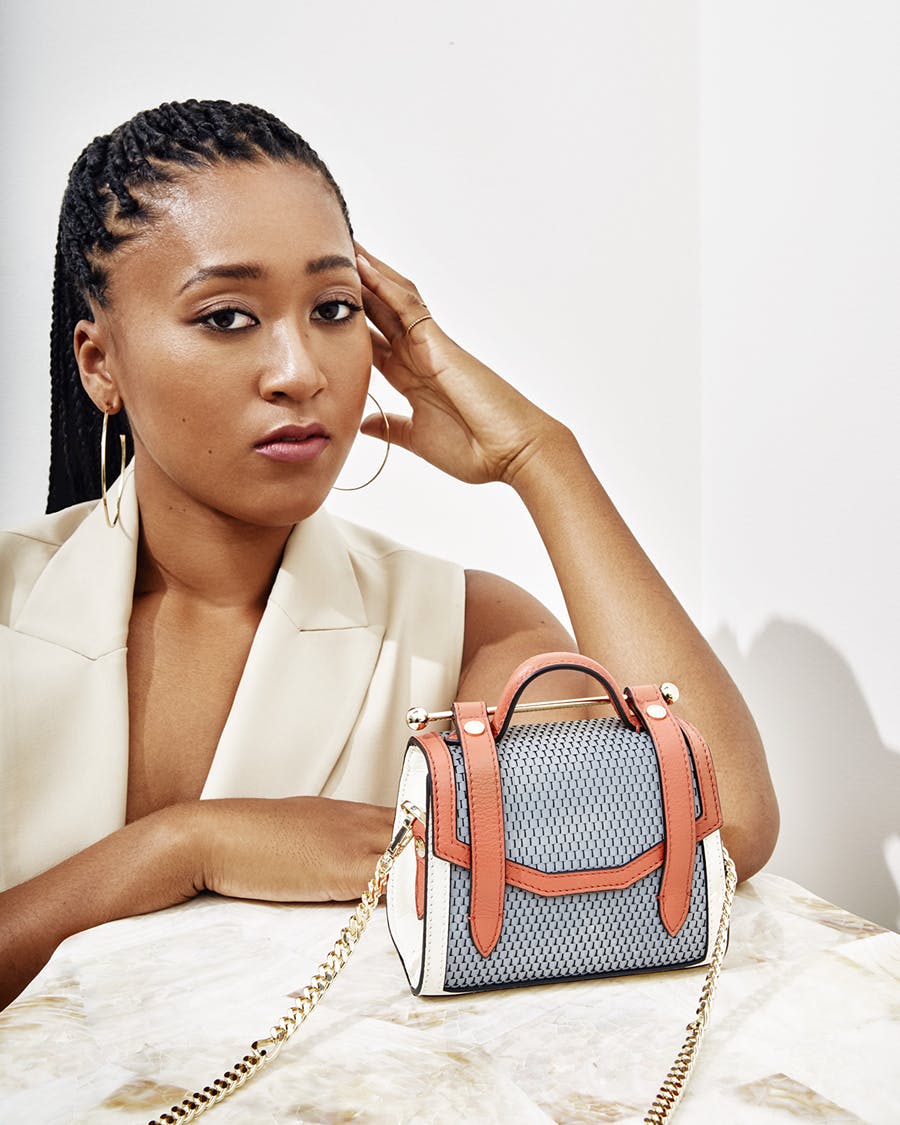 A woman sitting at a table with a handbag