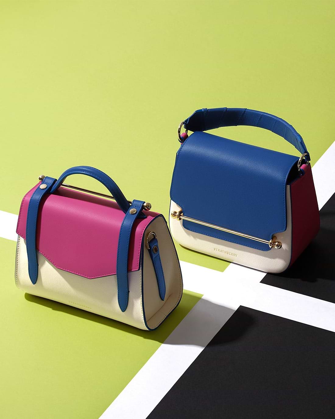 Two purses sitting side by side on a colorful surface