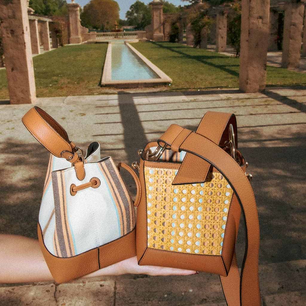 A person holding a purse in their hand