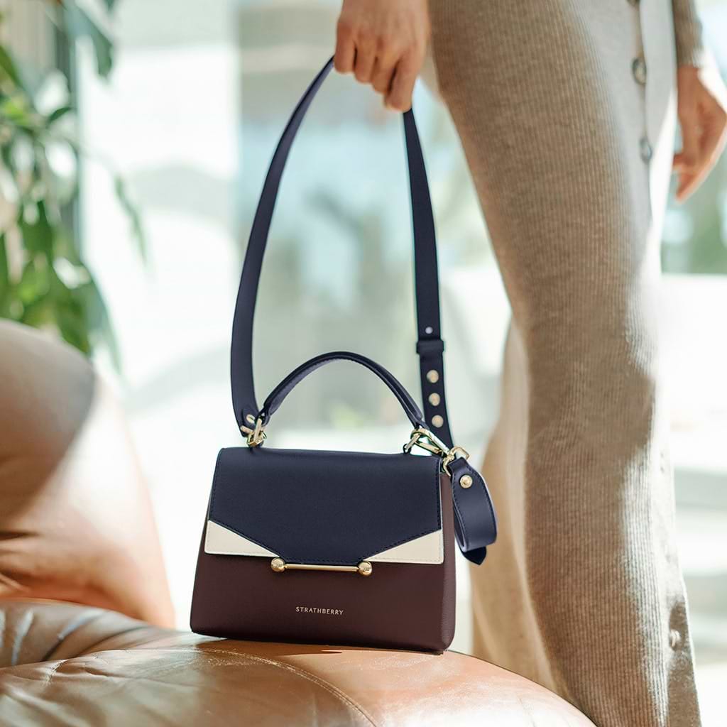 A woman carrying a purse on a couch