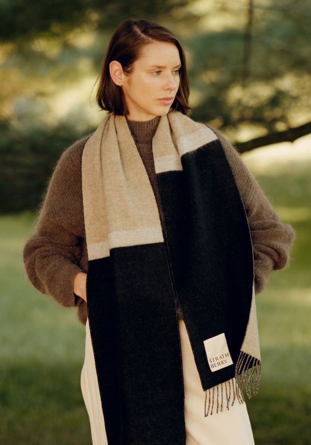 A woman wearing a black and grey scarf