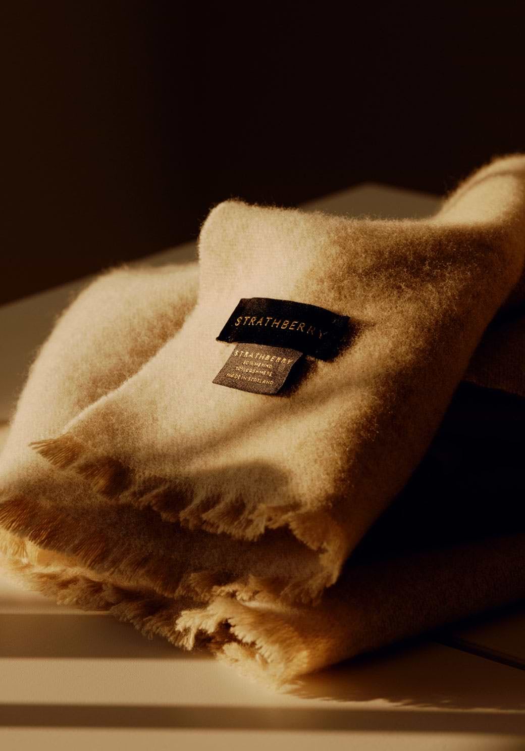 A pile of folded towels sitting on top of a counter