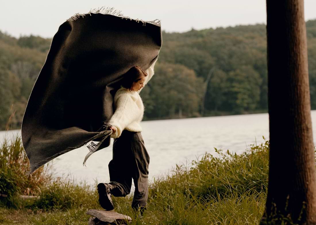 A person holding a black and white umbrella