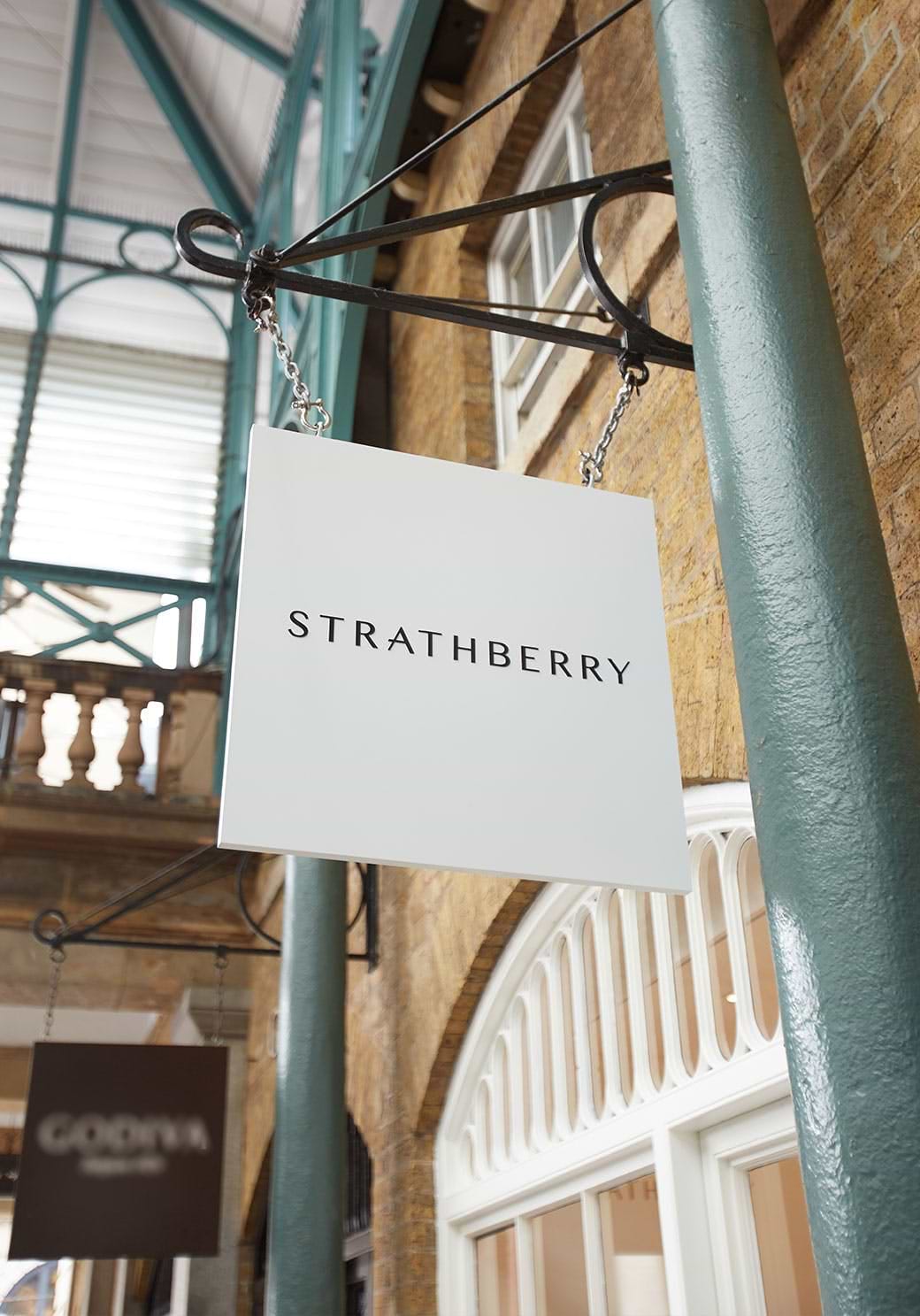 A sign hanging from the side of a building