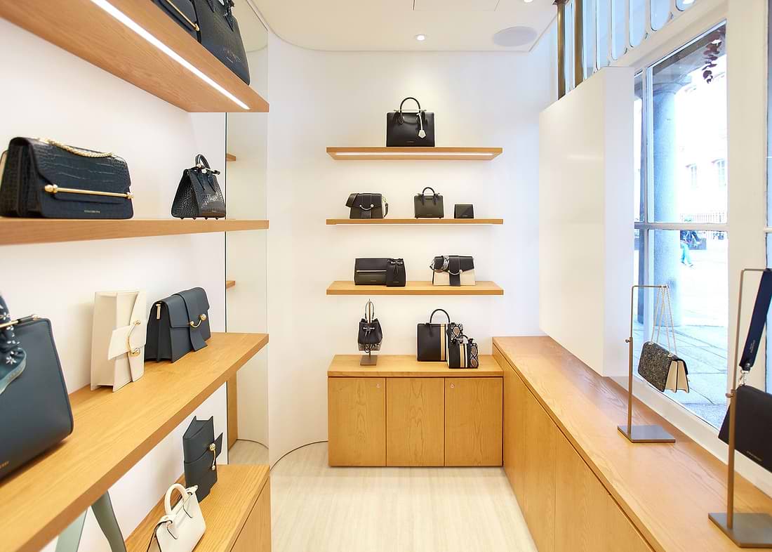 A store with wooden shelves filled with purses and handbags
