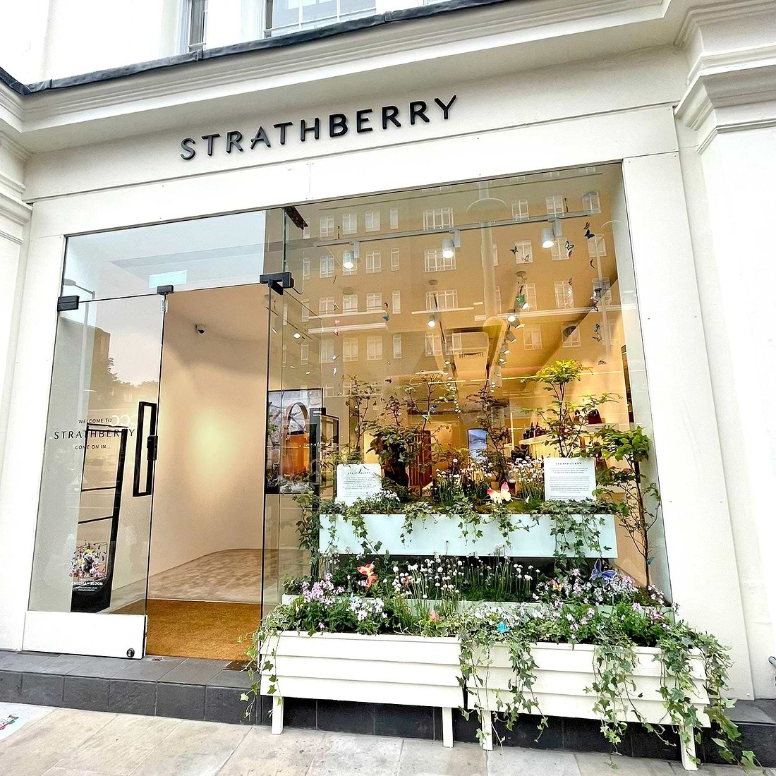 A store front with a bench in front of it