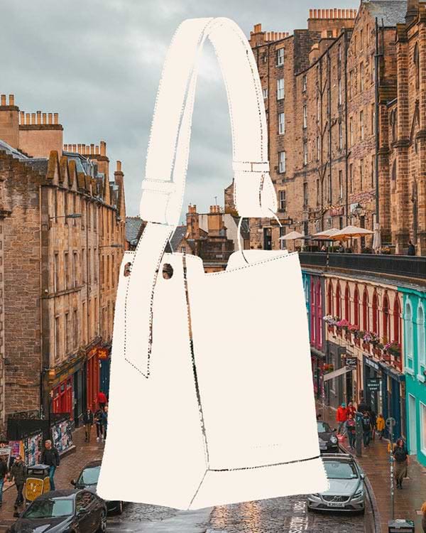 A white handbag hanging from the side of a building