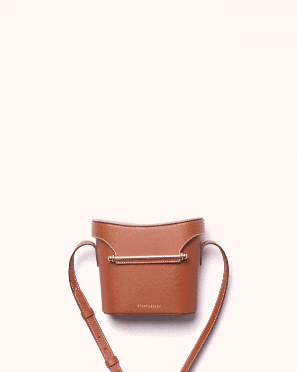 A small brown purse sitting on top of a white table