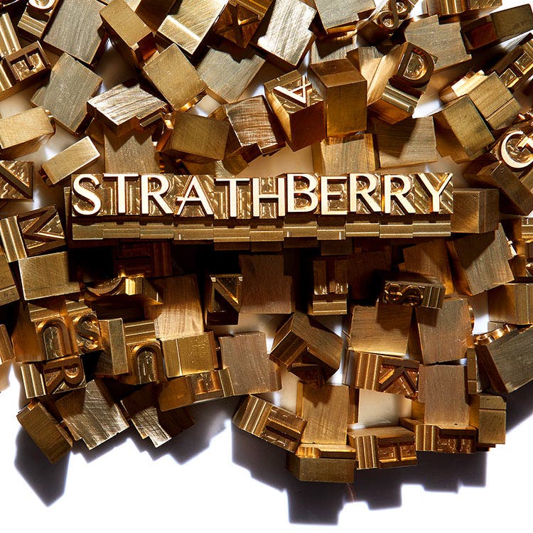A pile of wooden blocks with the word stratberry on them