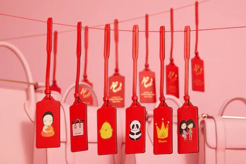 A bunch of tags are hanging on a line
