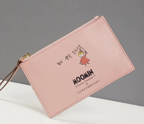 A pink purse with a picture of a woman on it