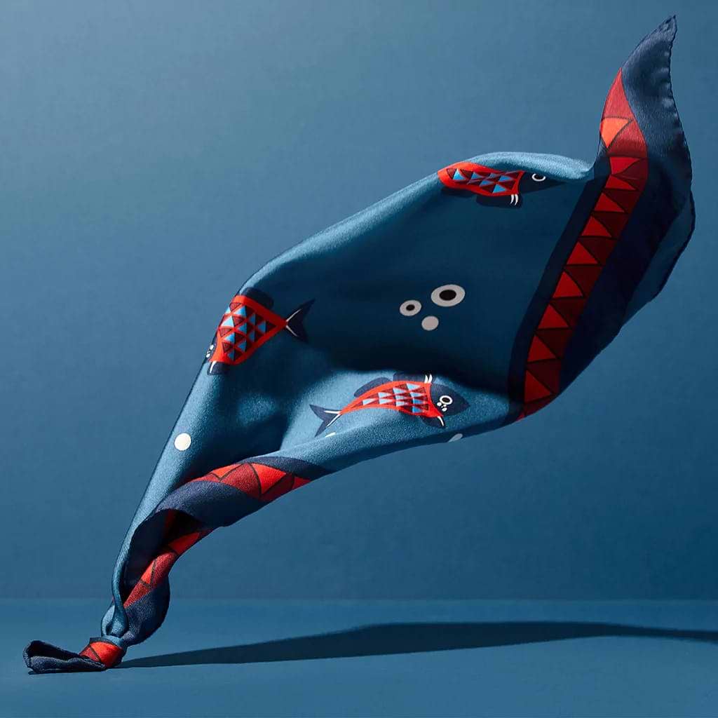 A kite shaped like a fish on a blue background