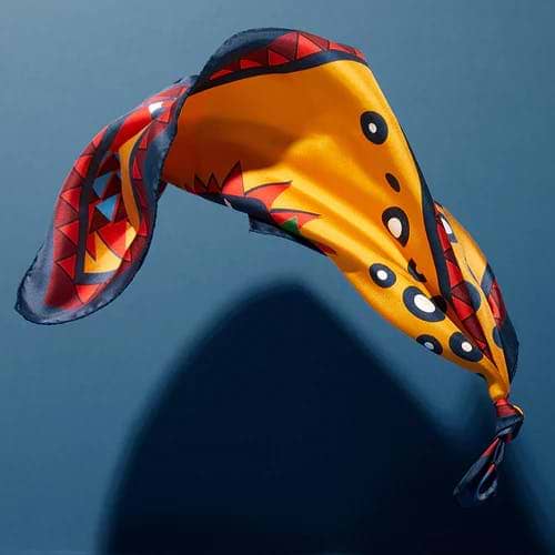 A kite flying in the air with a shadow on the ground