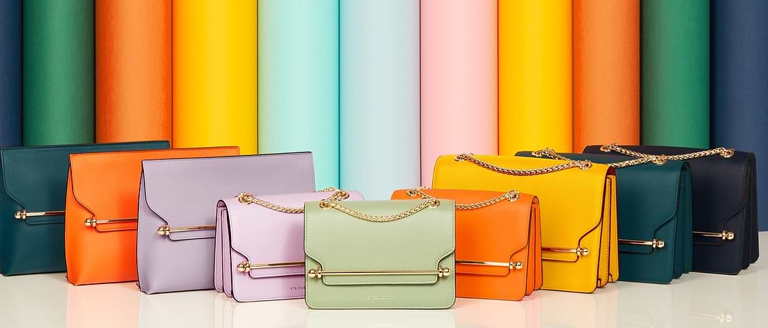 A row of multicolored bags sitting on top of a table