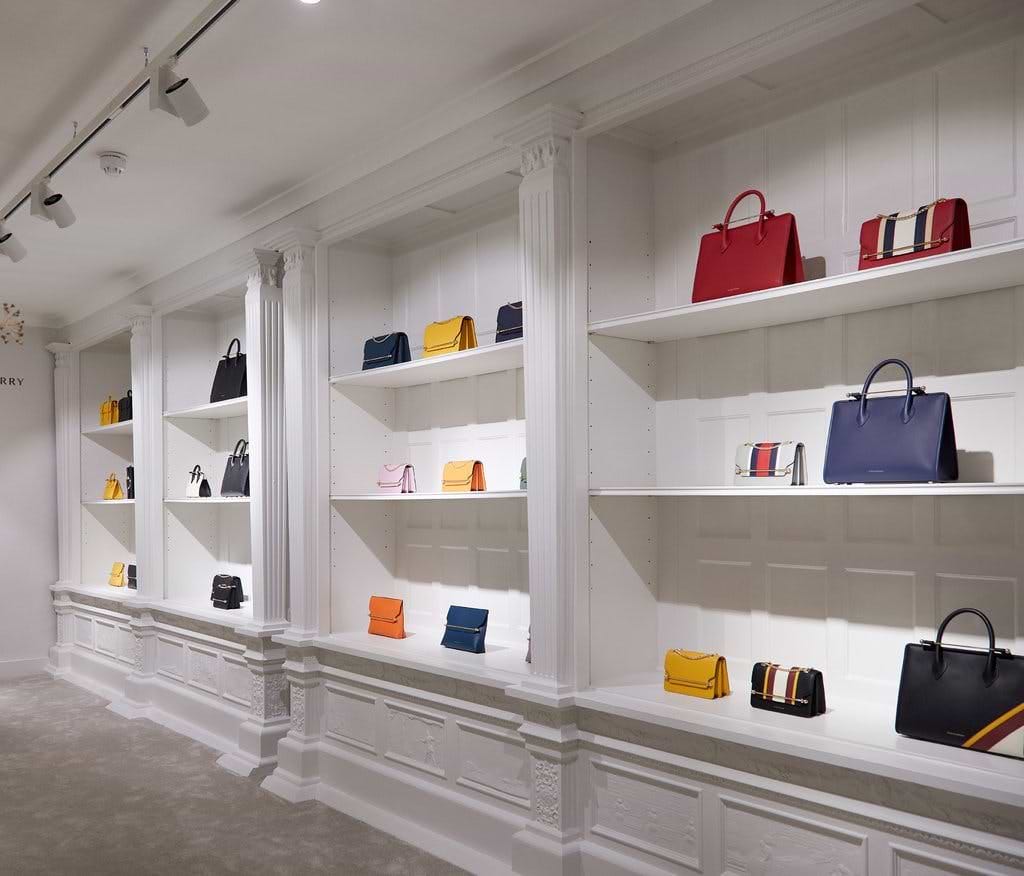 A row of shelves filled with purses and handbags