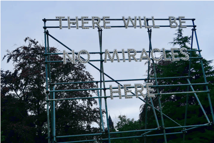 A large metal structure with a clock on top of it