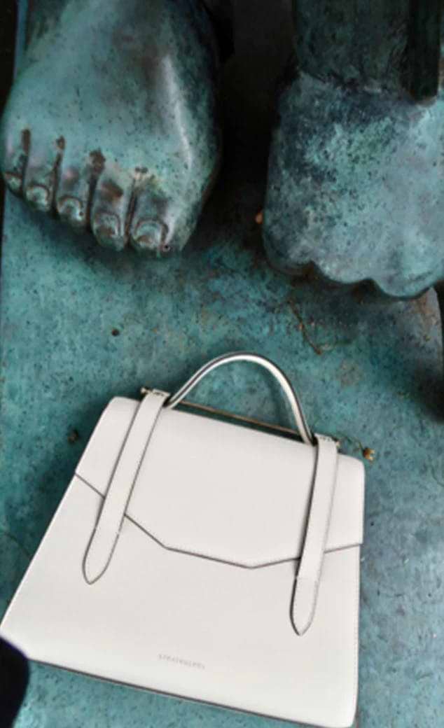 A white purse sitting on top of a blue table