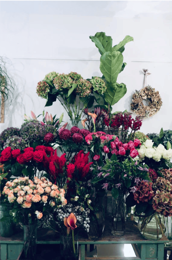 A table topped with lots of different types of flowers
