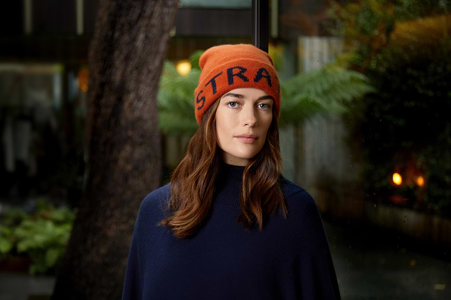 A woman wearing a hat with the word stra on it