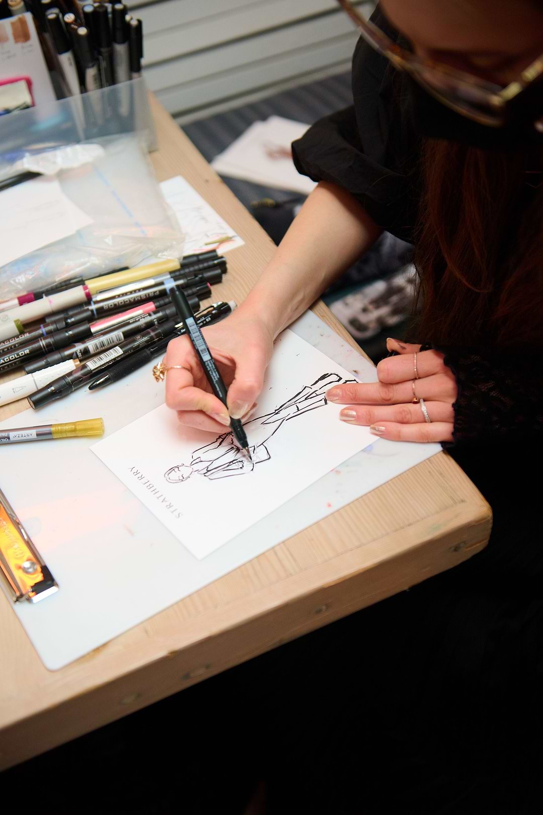 A woman is drawing on a piece of paper
