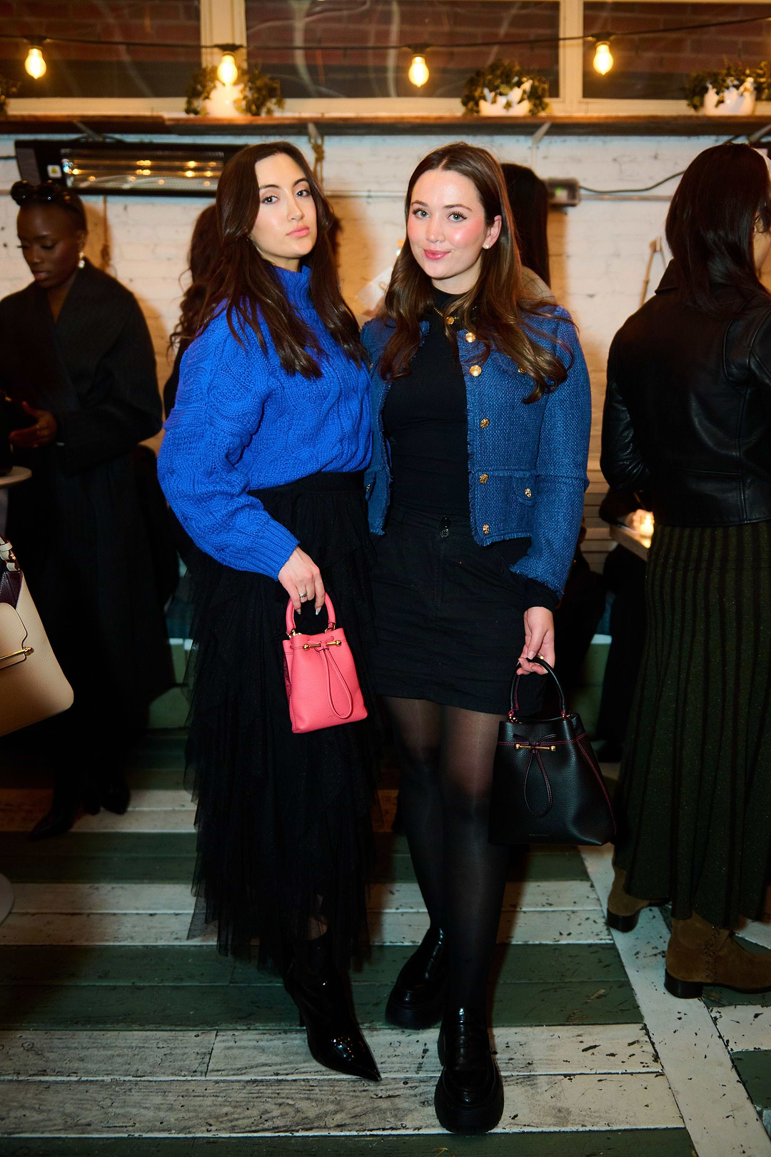 Two women standing next to each other in a room