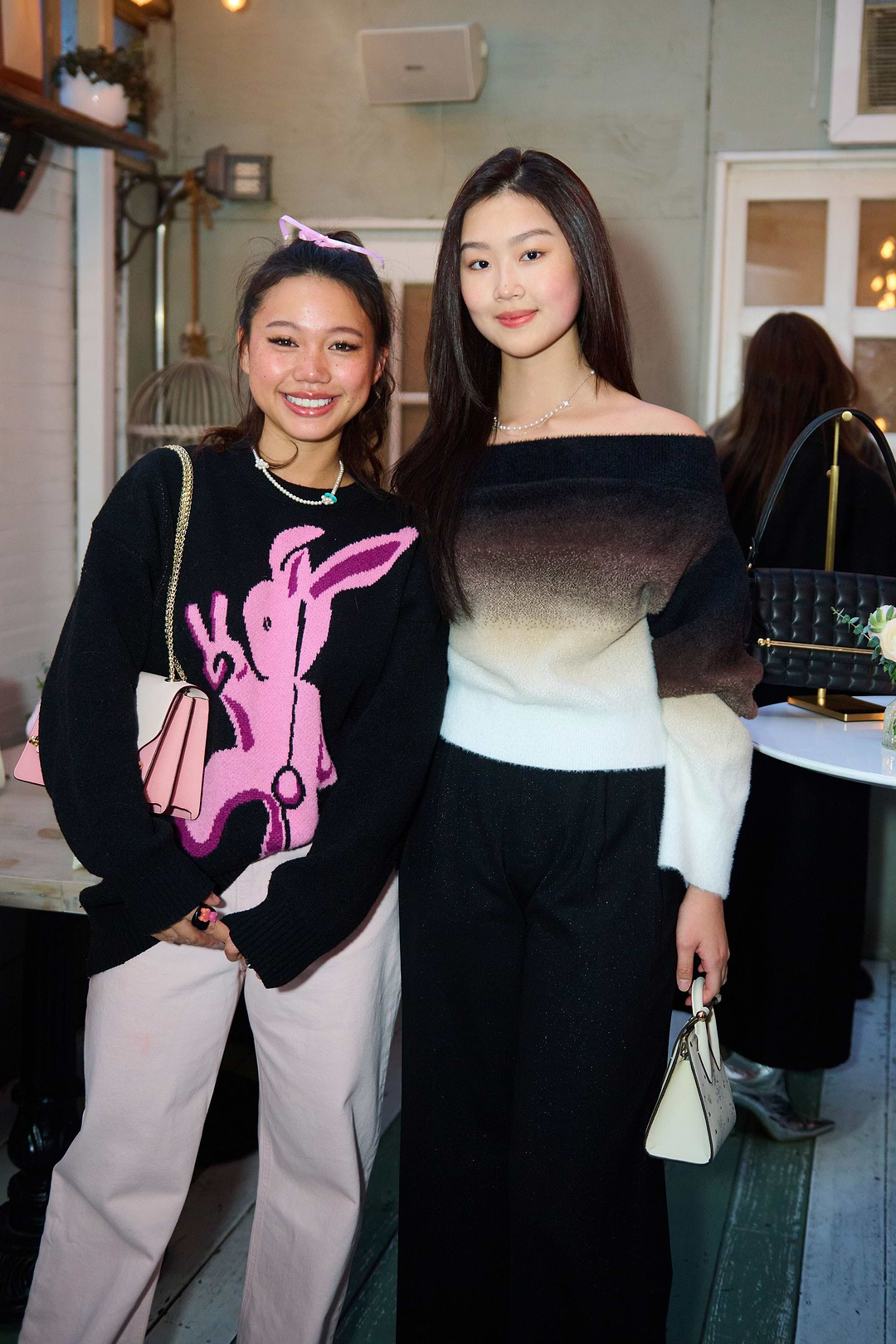 Two young women standing next to each other