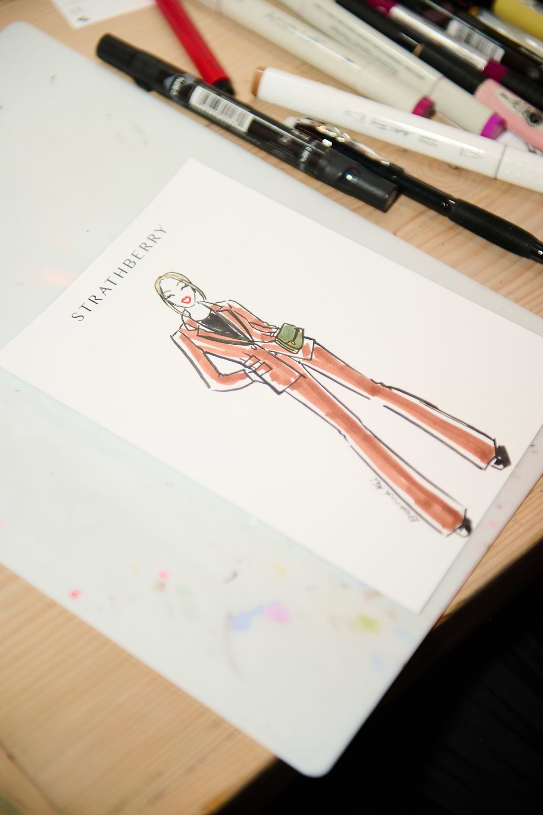 A drawing of a woman's overalls and a pair of scissors