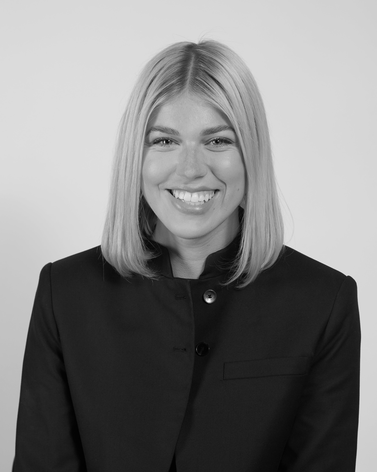 A black and white photo of a woman smiling
