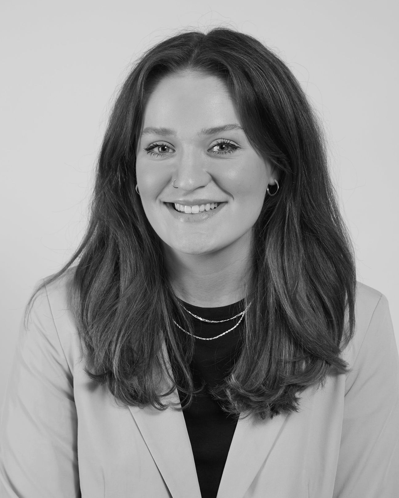 A black and white photo of a smiling woman