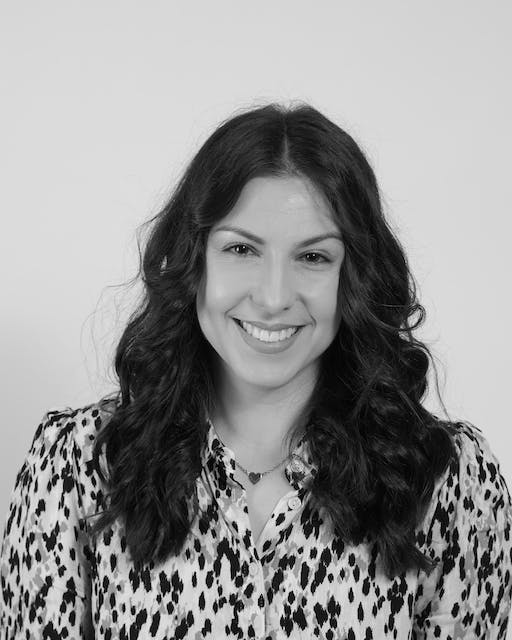 A black and white photo of a woman smiling