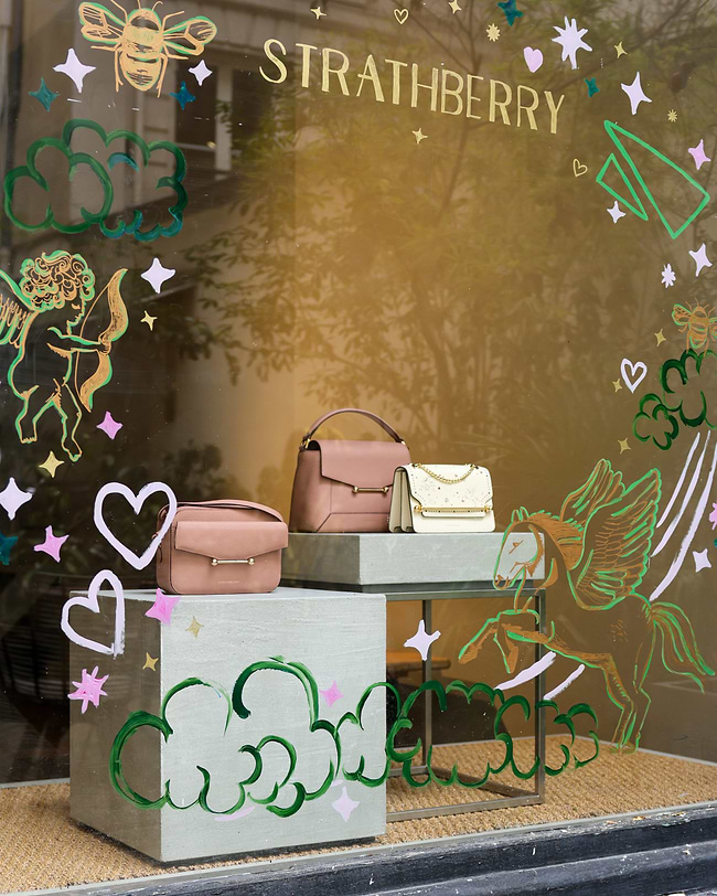A window display with a variety of purses