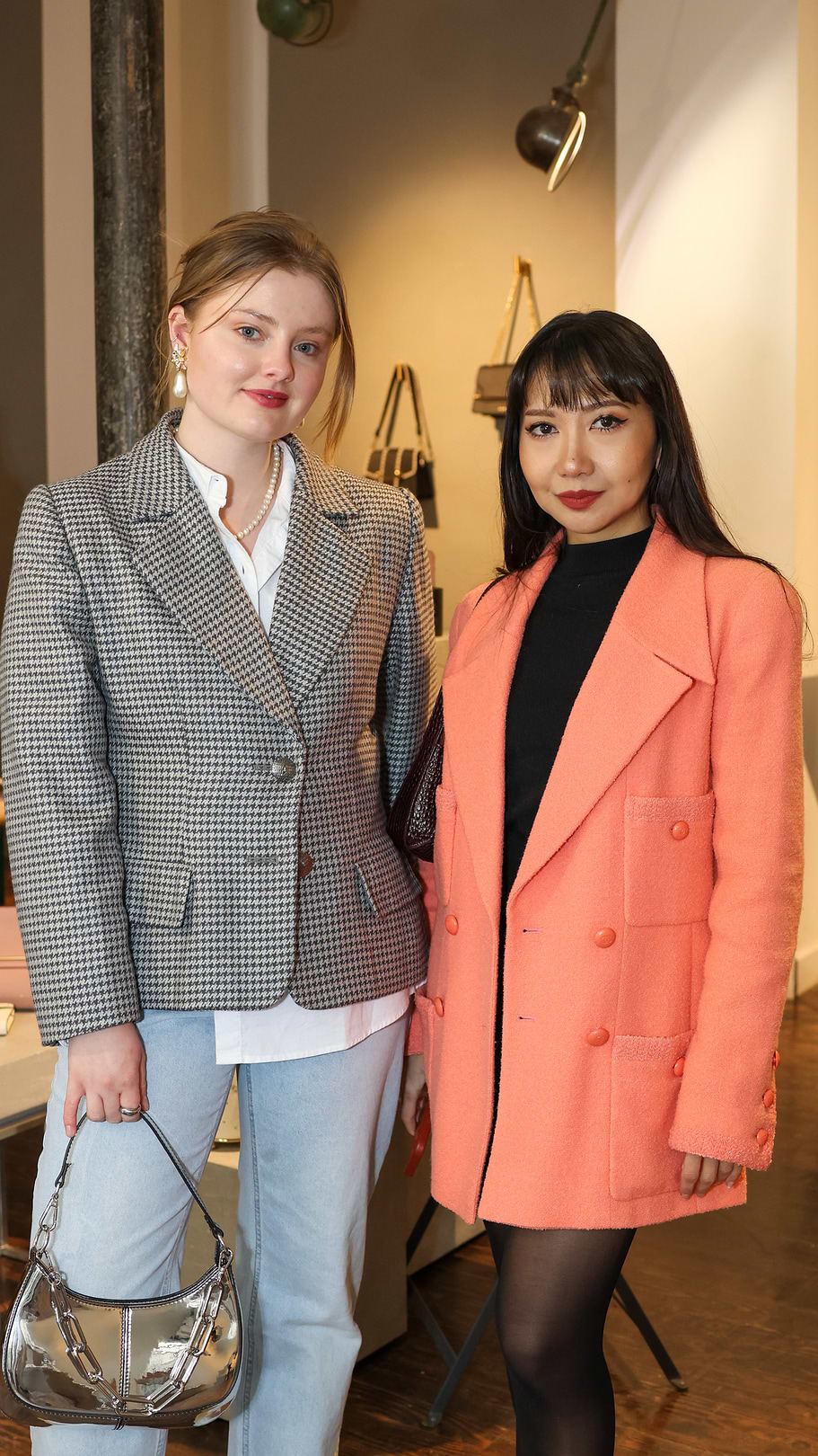 Two women standing next to each other in a room