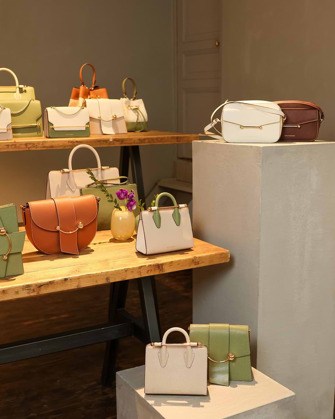 A table with a bunch of purses on it