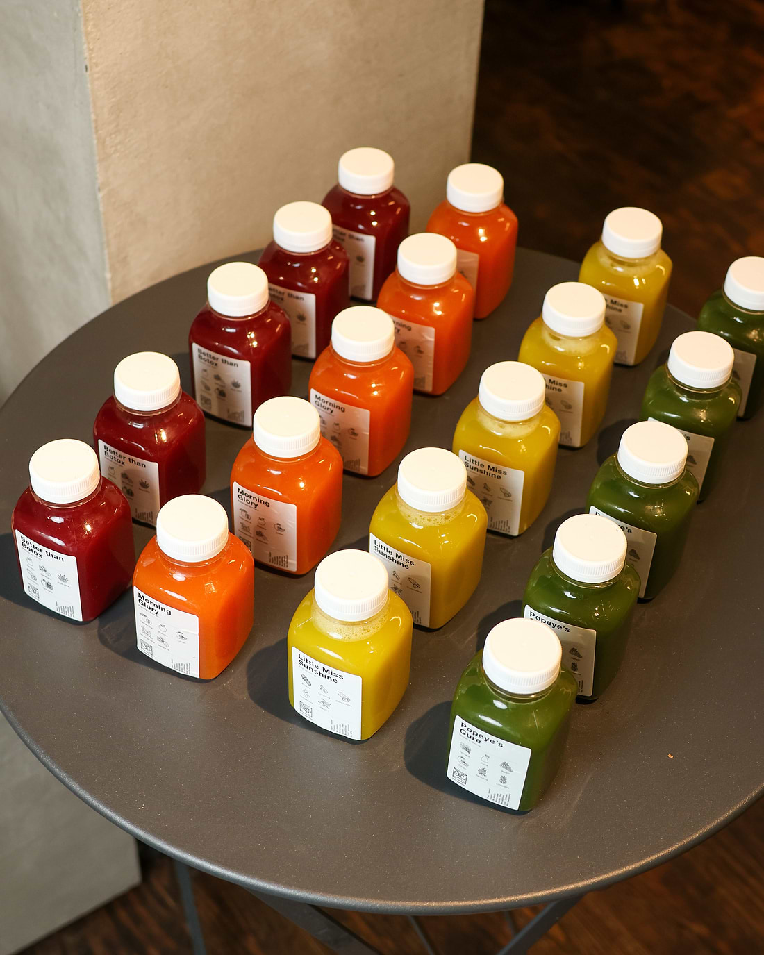A table topped with lots of bottles of juice