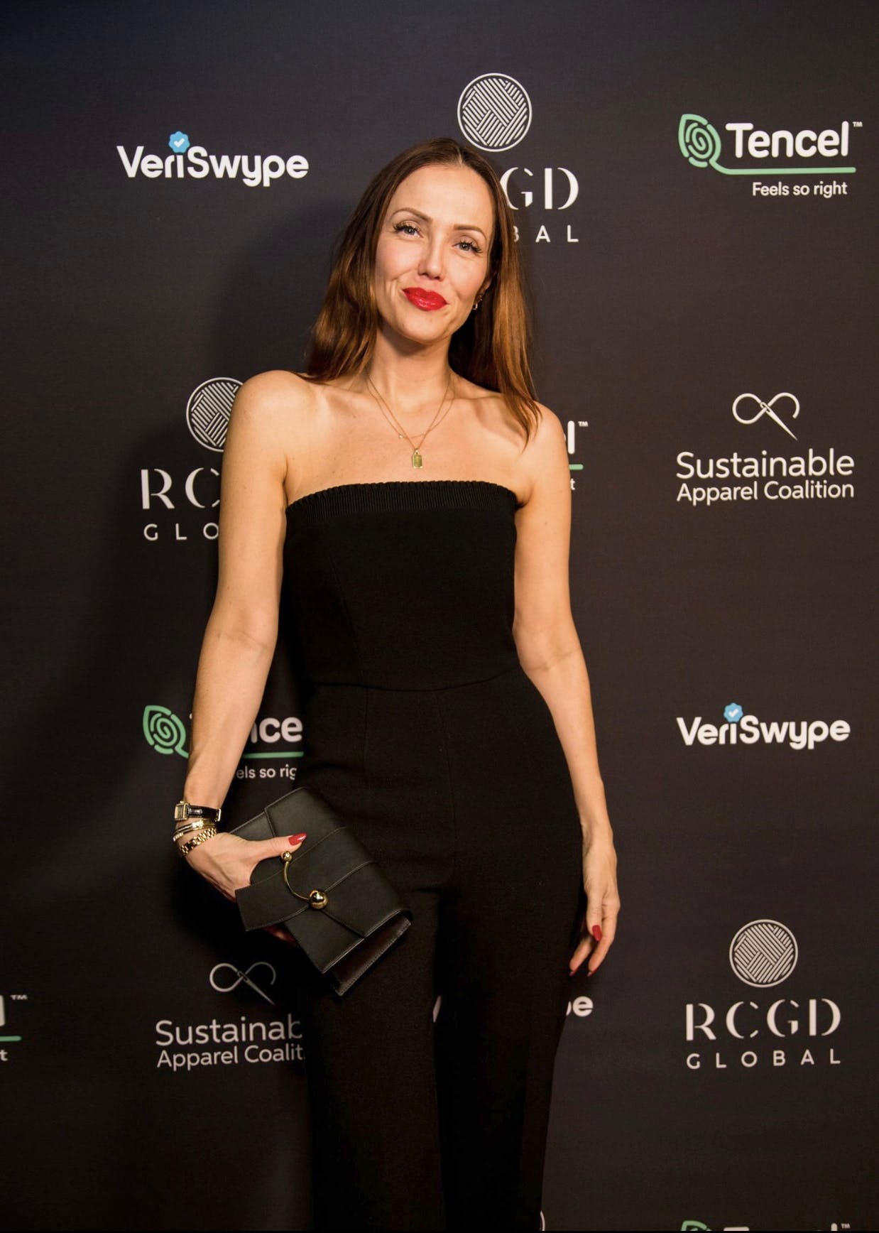 A woman in a strapless black jumpsuit at an event