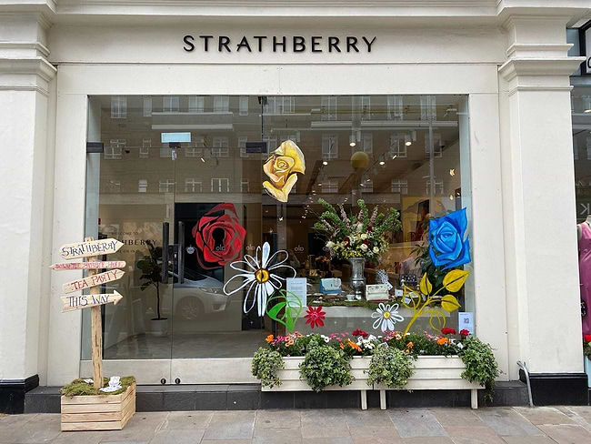 A store front with flowers in the window