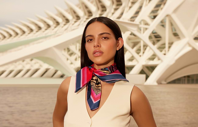 A woman standing in front of a large building