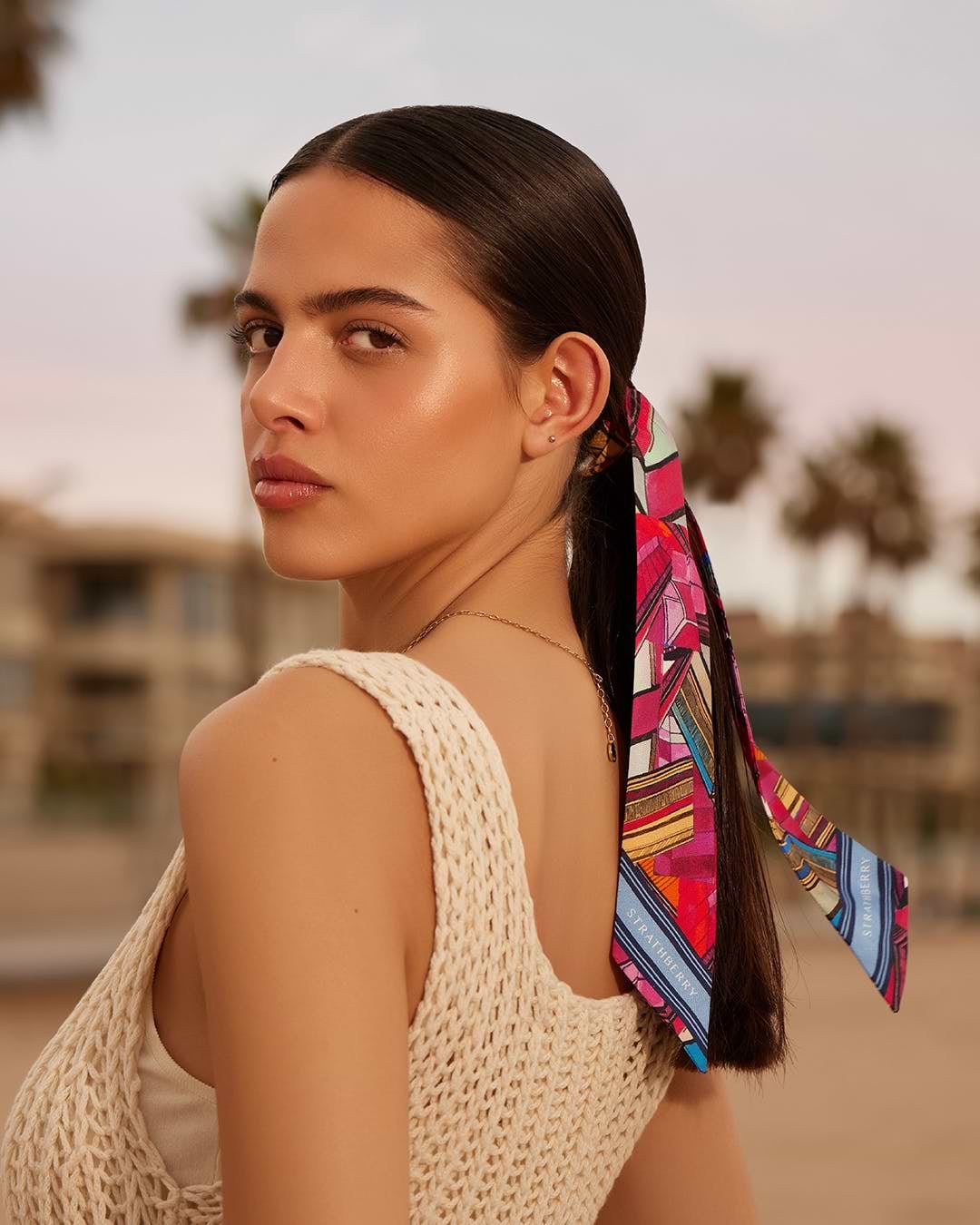 A woman with a colorful tie around her neck