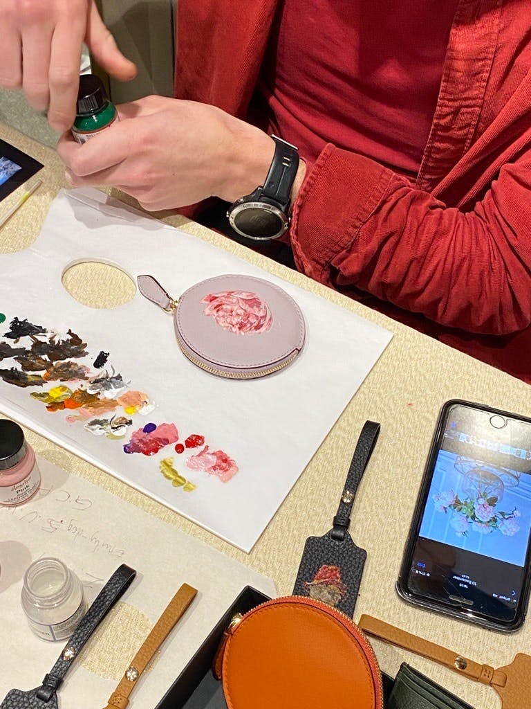 A person sitting at a table using a cell phone
