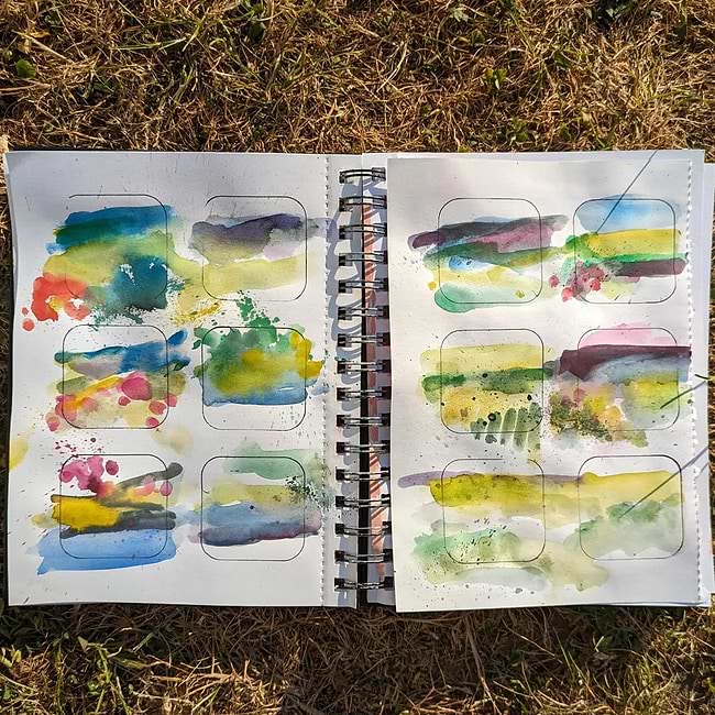 A book with a bunch of watercolors on it