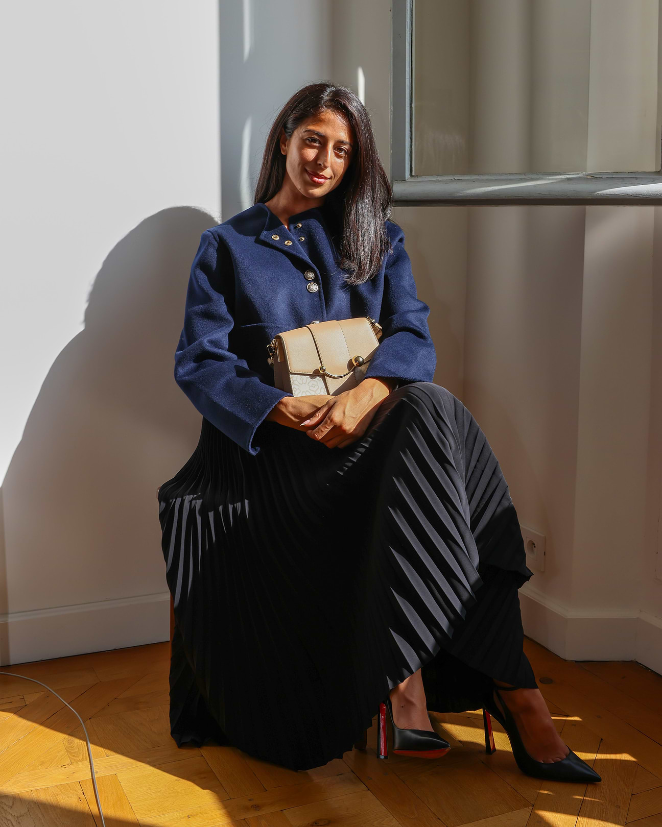 A woman sitting on a chair holding a book