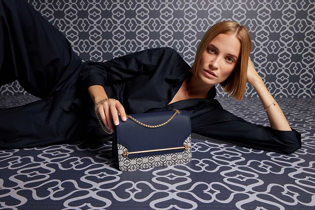 A woman laying on the floor with a purse