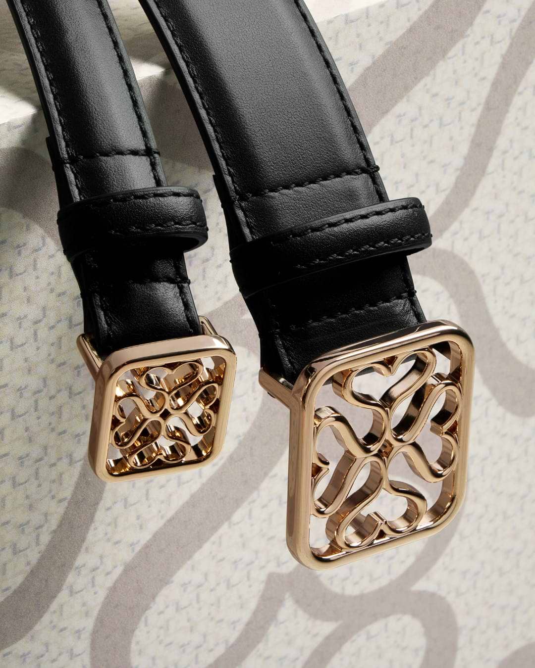 A close up of a pair of black leather straps